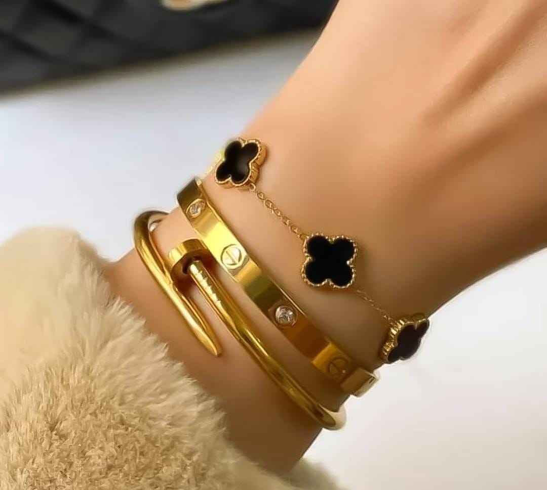 Three stackable gold bangles worn on wrist